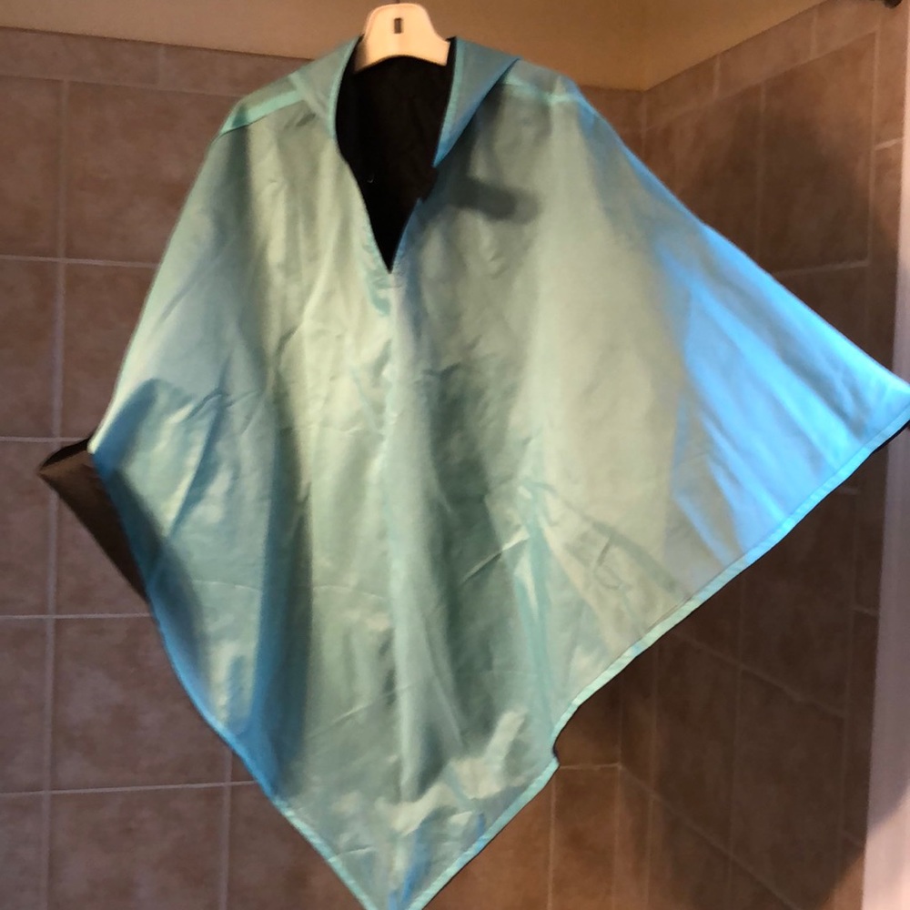 Hooded, reversible rain poncho. NEVER worn!